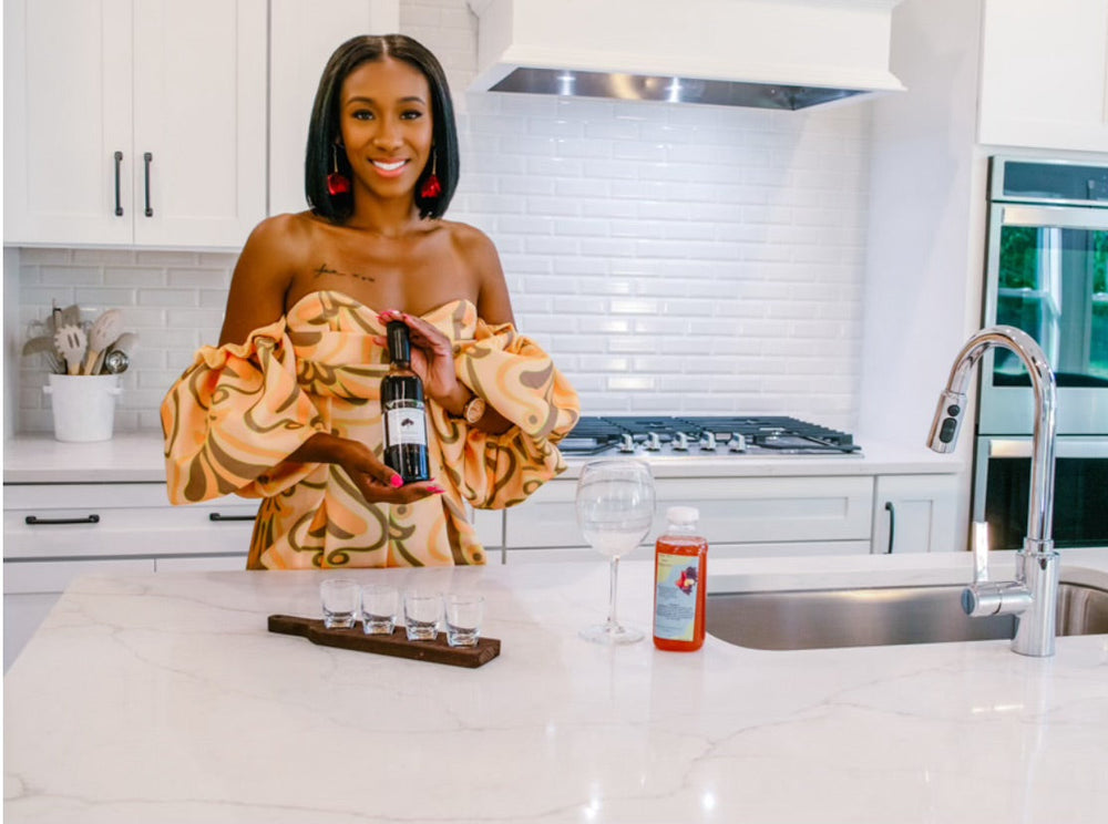 Woman holding a bottle in a modern kitchen